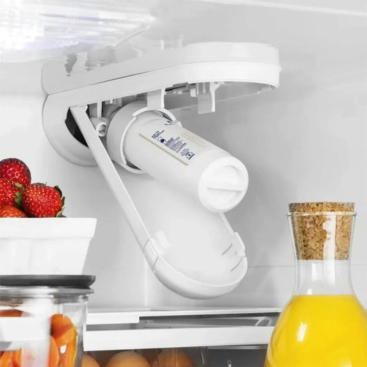 White refrigerator door organizer with items inside a refrigerator